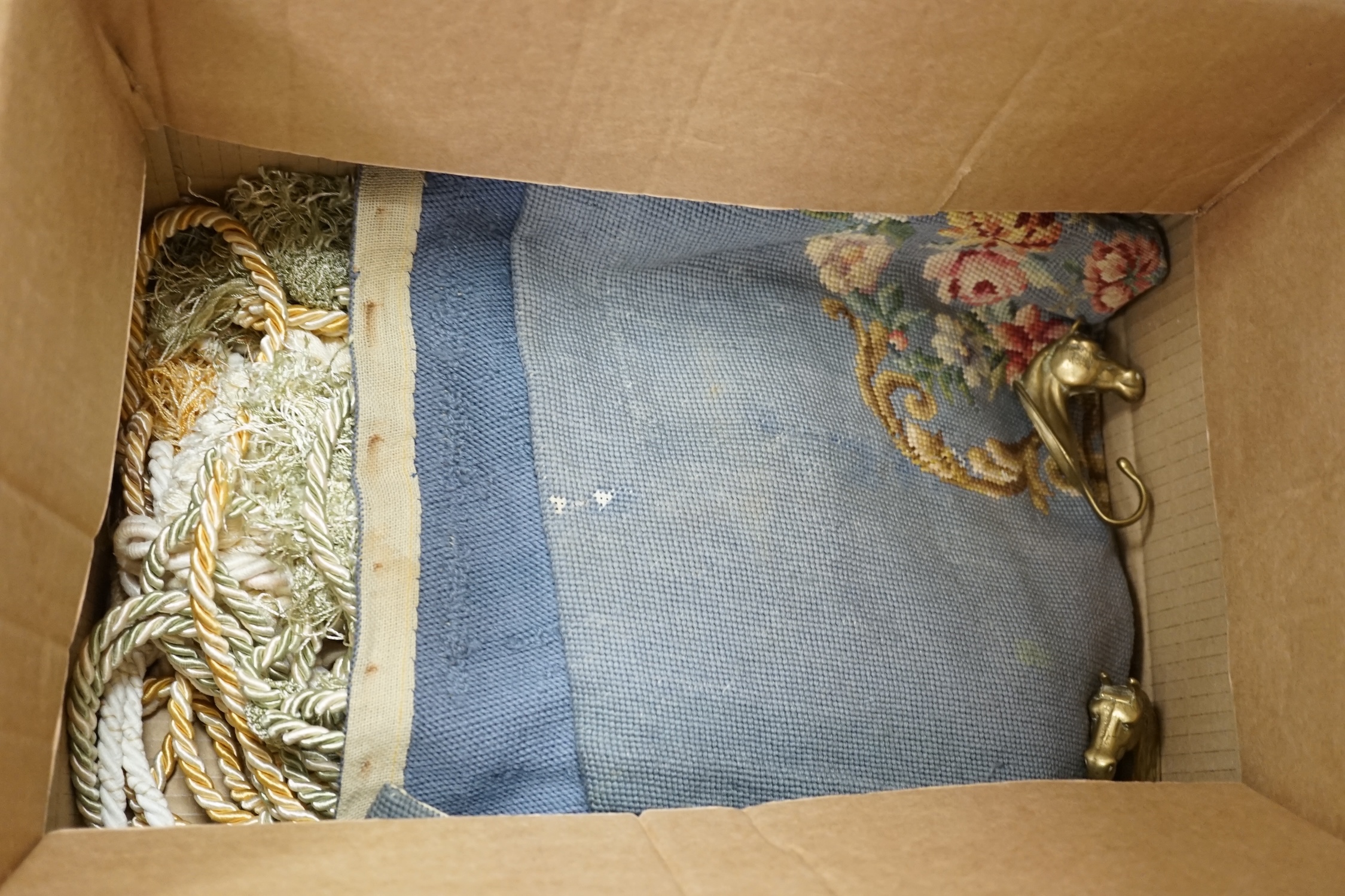 A collection of tie backs and needlepoint cushion covers and panels and two horse's head wall hooks
